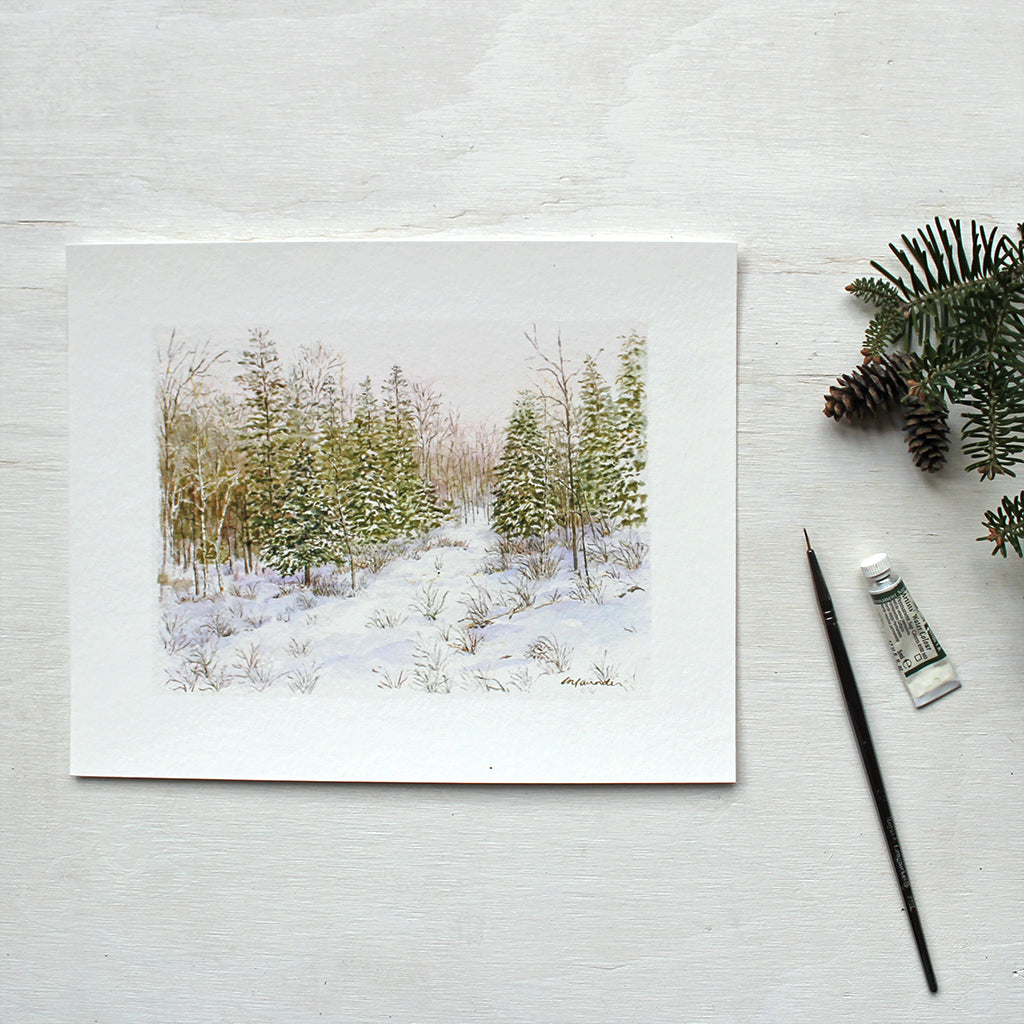 An art print featuring a delicate and detailed watercolour of a winter forest painted by Kathleen Maunder