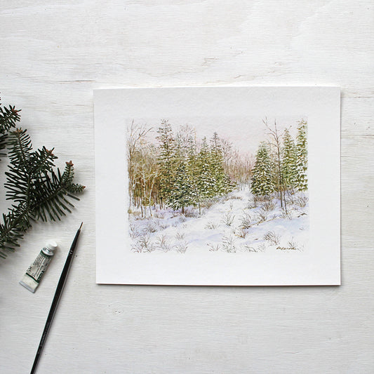 Winter Forest Print featuring a peaceful watercolor painting of a snowy forest by Kathleen Maunder