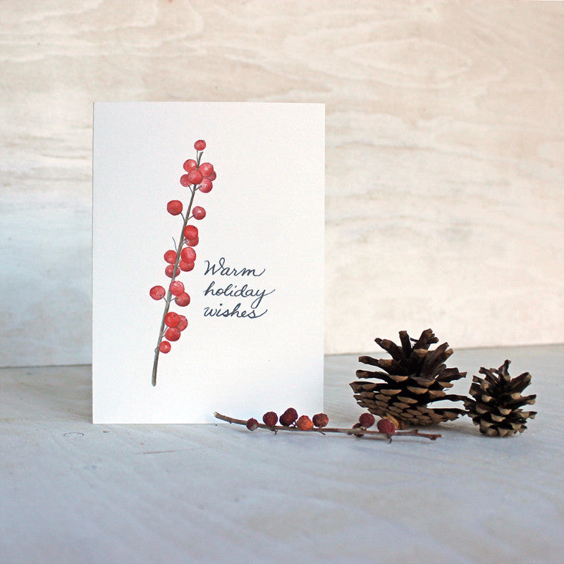 This lovely holiday note card features a watercolor image of a twig of bright red winterberries and a hand lettered greeting. Painting by Kathleen Maunder