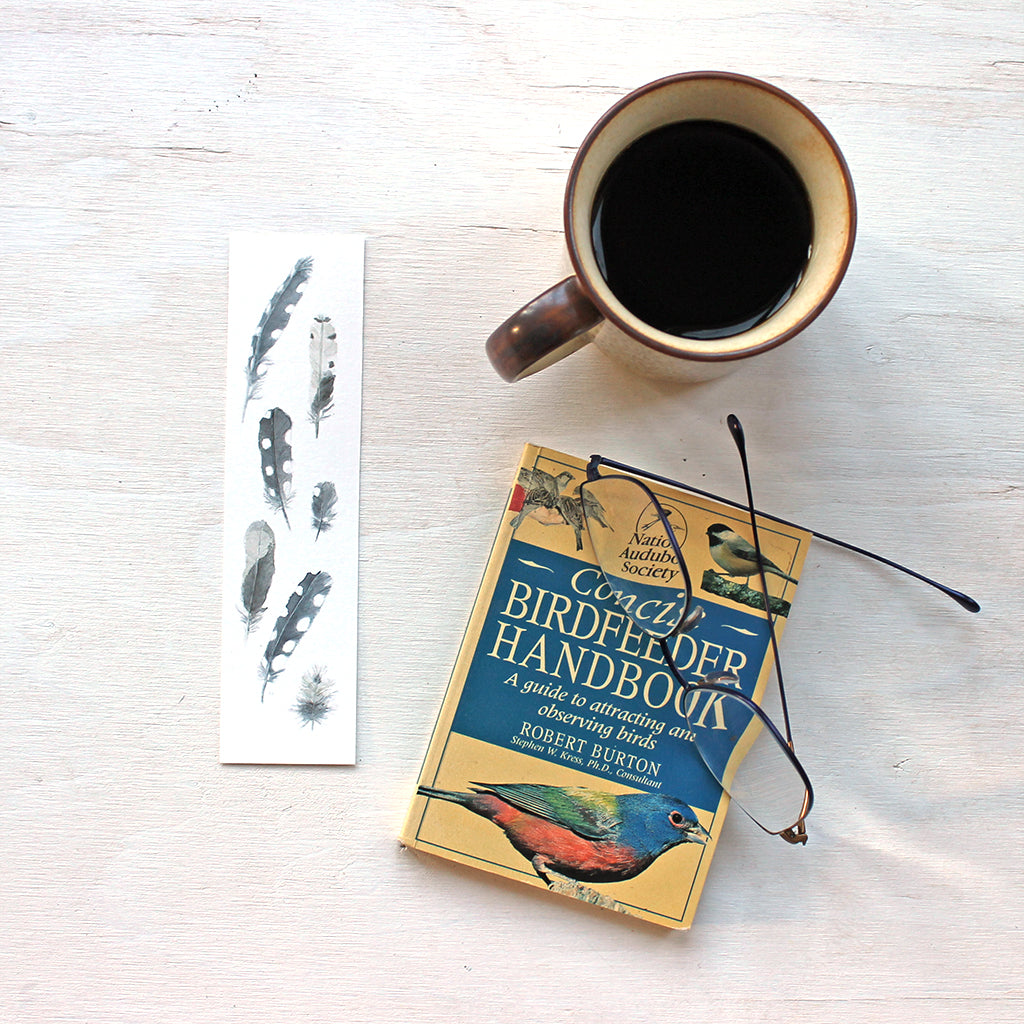 Bookmark featuring a painting of woodpecker feathers by watercolor artist Kathleen Maunder 