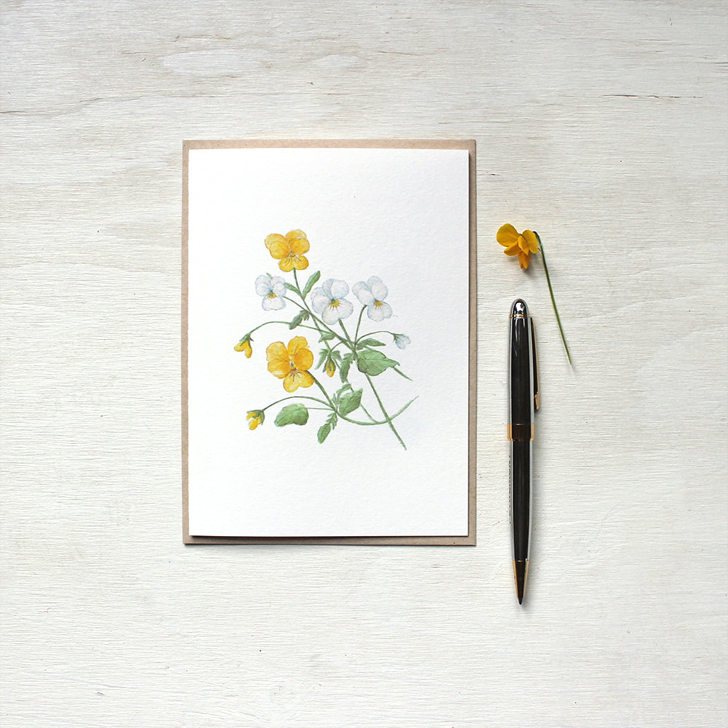 Botanical note card featuring a painting of yellow and white violas by watercolor artist Kathleen Maunder.